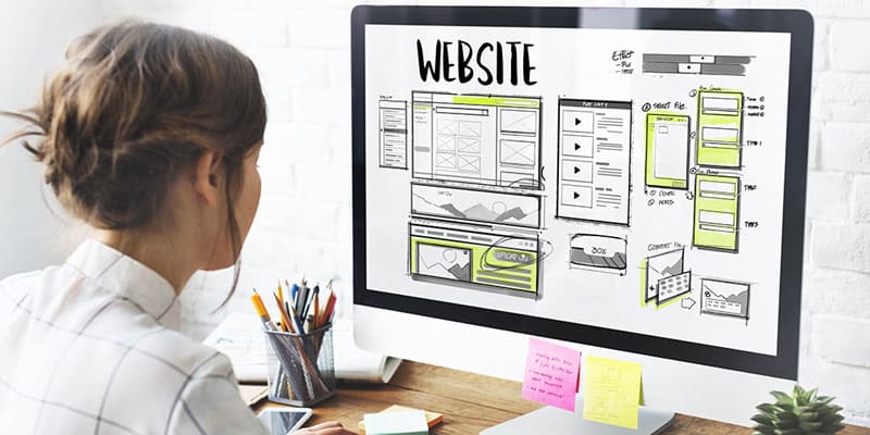 Graphic designer builds an ADA-compliant website on her computer.