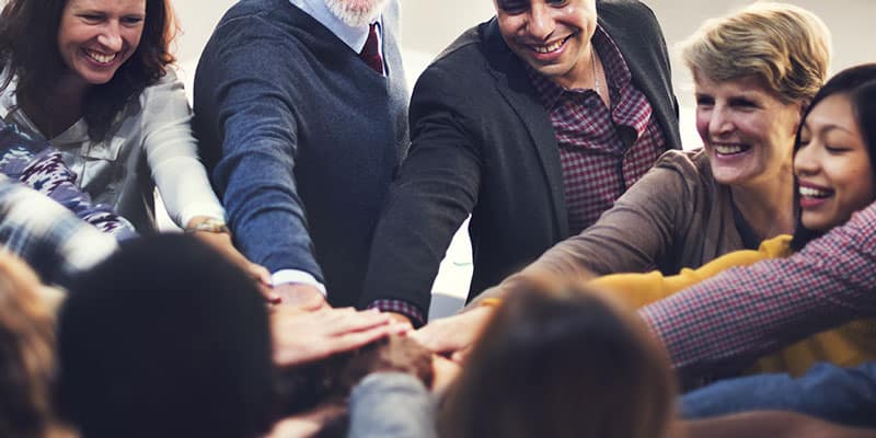 Team members put their hands in after a co-op advertising win.
