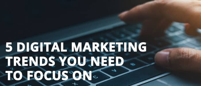 Business person types on keyboard researching digital marketing trends.