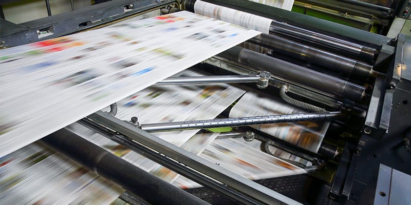 Printing press printing large format magazine.